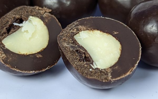 Macfarms kona coffee dark chocolate macadamias close up cross section view - familyguidecentral.com
