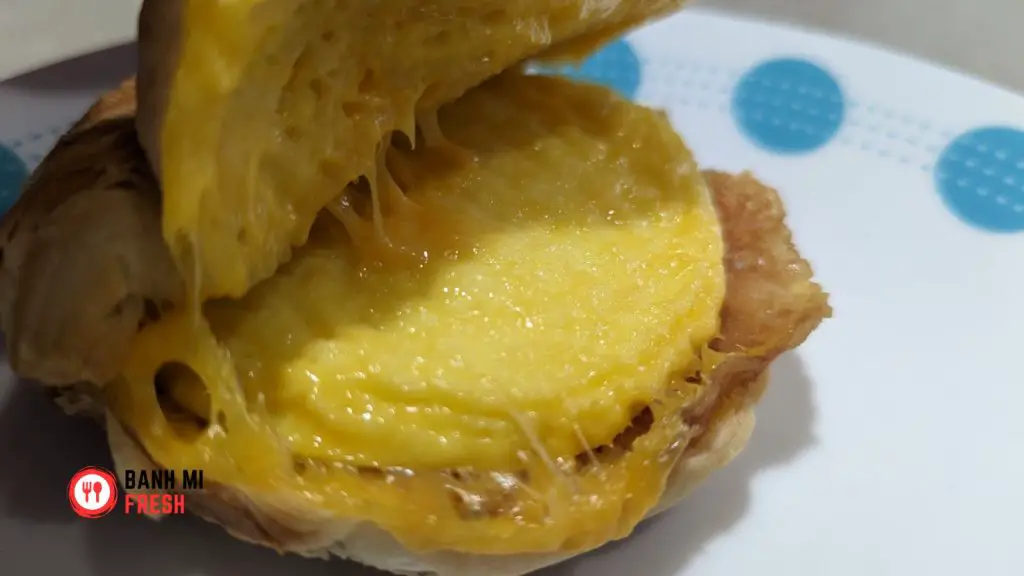 Jimmy Dean Croissant Bacon, Egg, and Cheese cooked lifting up bread - banhmifresh.com