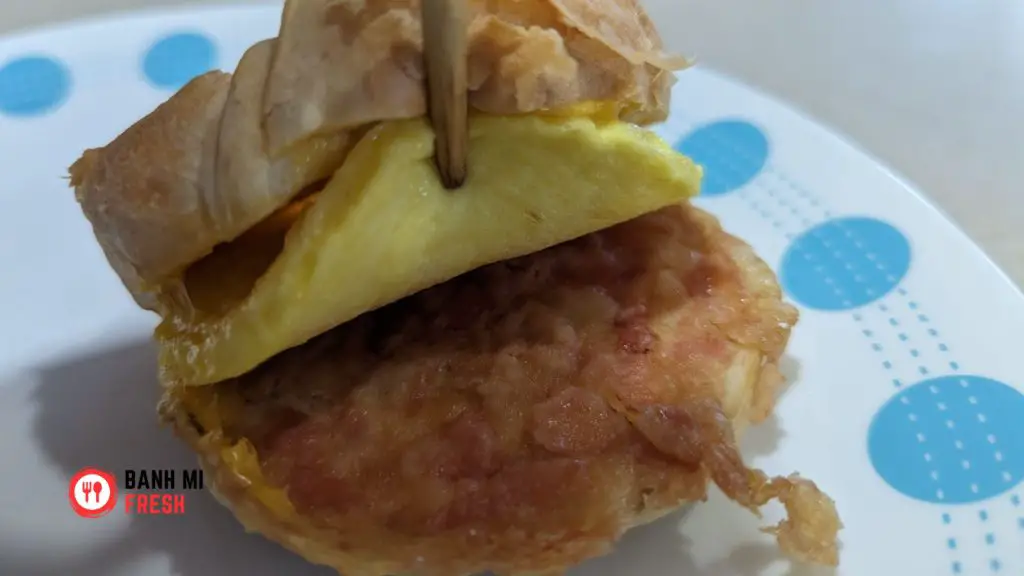 Jimmy Dean Croissant Bacon, Egg, and Cheese lifting up eggs - banhmifresh.com